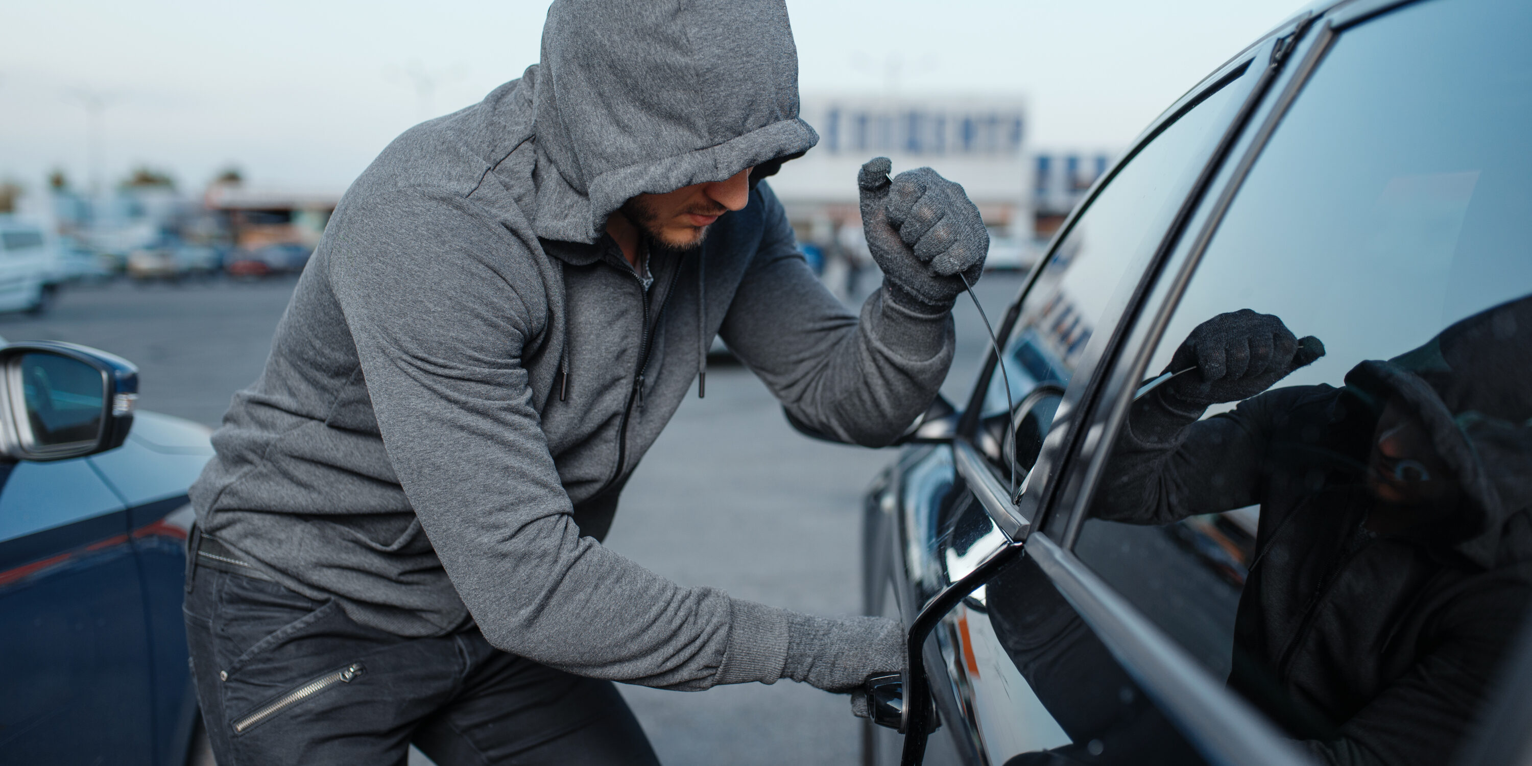 Car thief breaking door lock, criminal job