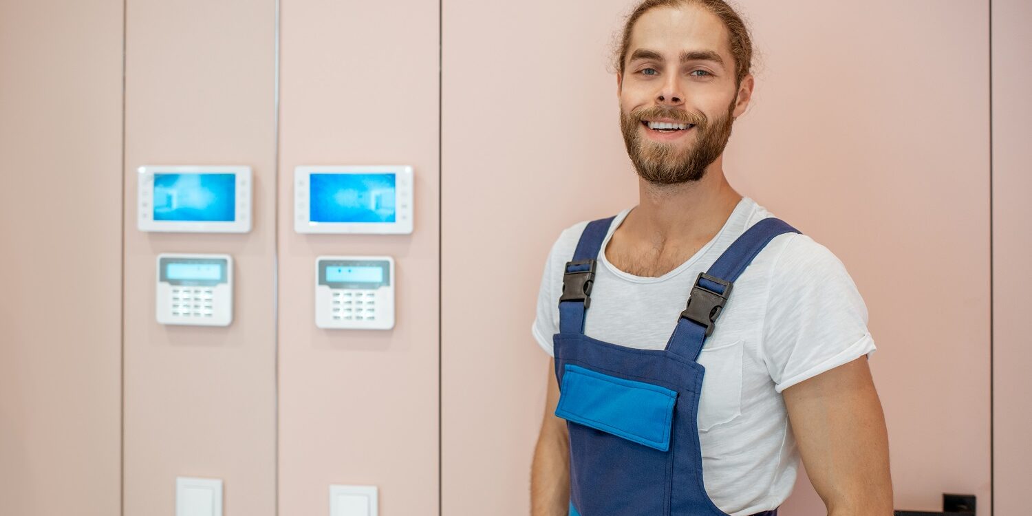 Electrician setting up the home alarm