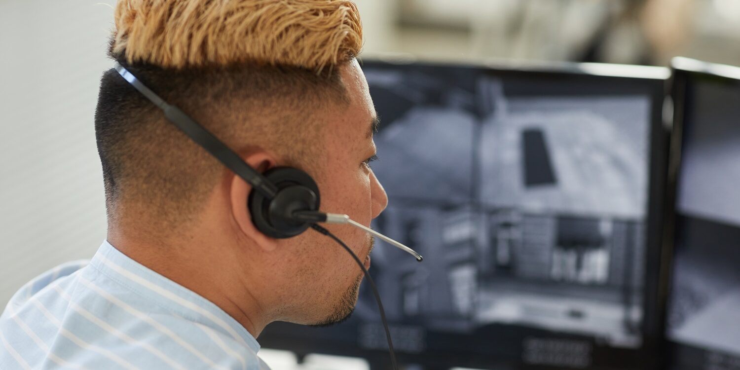Close up Asian man wearing headset in monitoring and security office