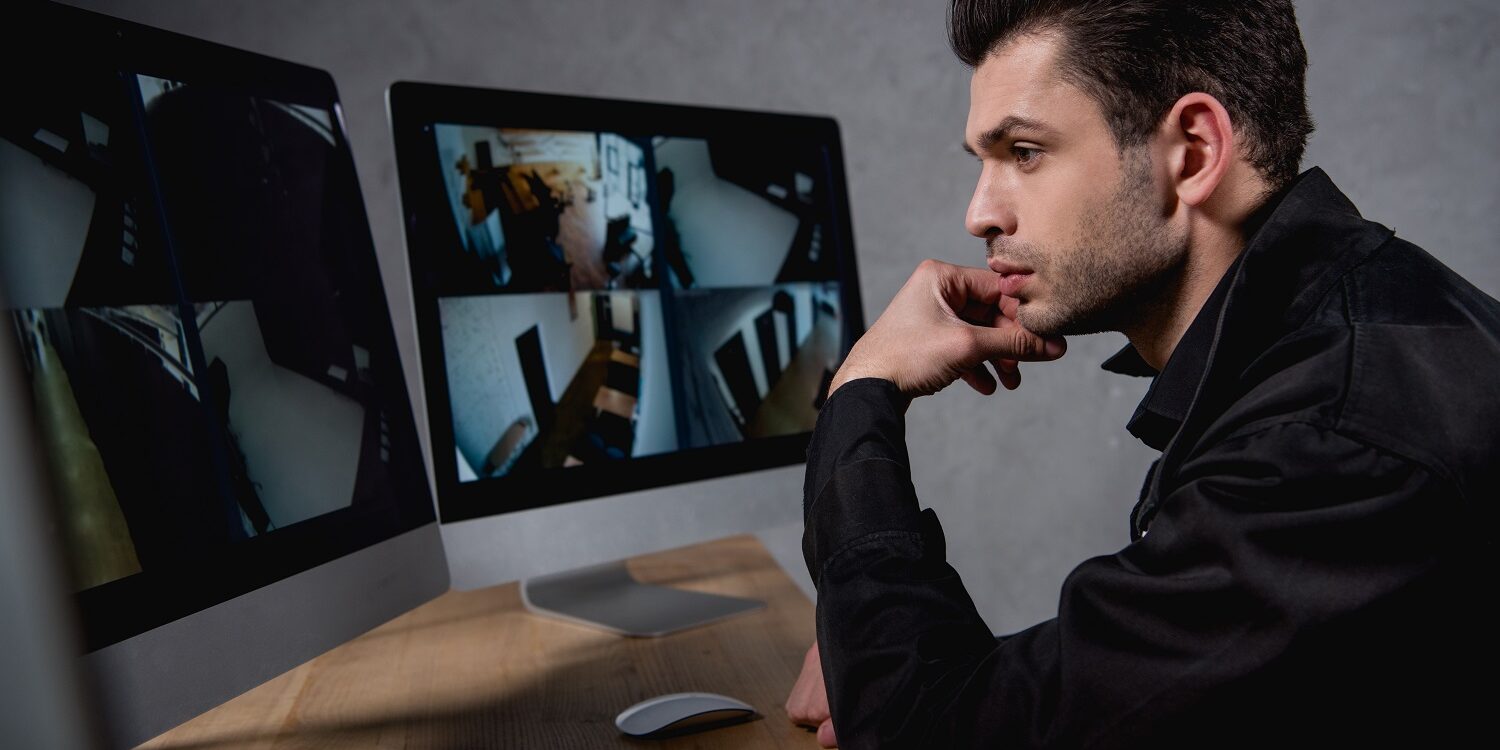 handsome guard in uniform looking at computer monitor